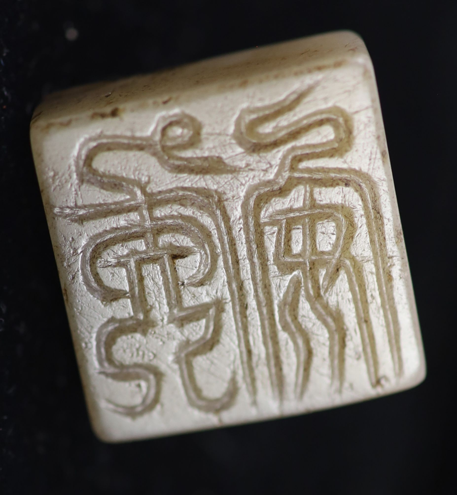 A Chinese grey and black jade square seal, 2.7cm